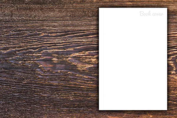 Blank book or magazine cover on wood background