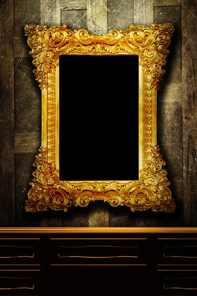 Gallery display - vintage gold frames on an old timber wall