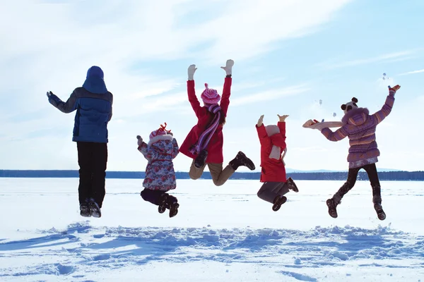 Group of cheerful children jumping in winter