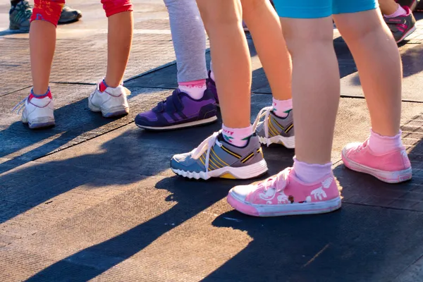 Group of children\'s feet in sneakers
