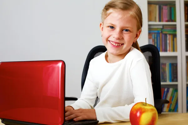 Schoolgirl working on a laptop