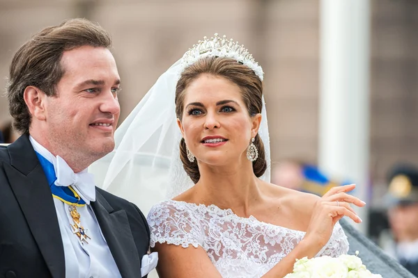 STOCKHOLM, Sweden - JUNE 8: Princess Madeleine and Chris ONeill ride in a carriage on the way to Riddarholmen after their wedding in Slottskyrkan. June 8, 2013, Stockholm, Sweden