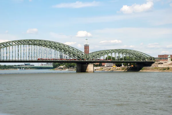 A train crosses the Hohenzollernbruecke over the Rhine in Cologn