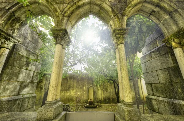 Ancient gothic arches in the myst. Fantasy landscape in Evora, Portugal.