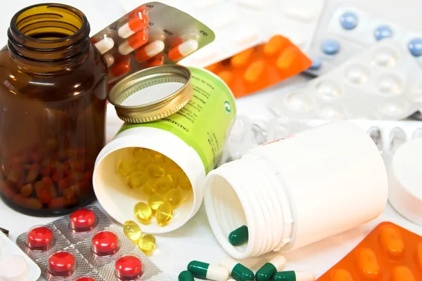 Detail of medicine bottles with spilled pills.