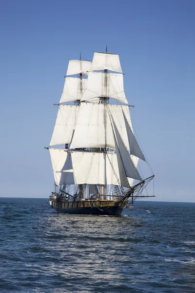 Tall ship sailing on blue waters