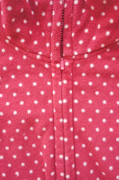 Closeup of zipper opening red fleece jacket