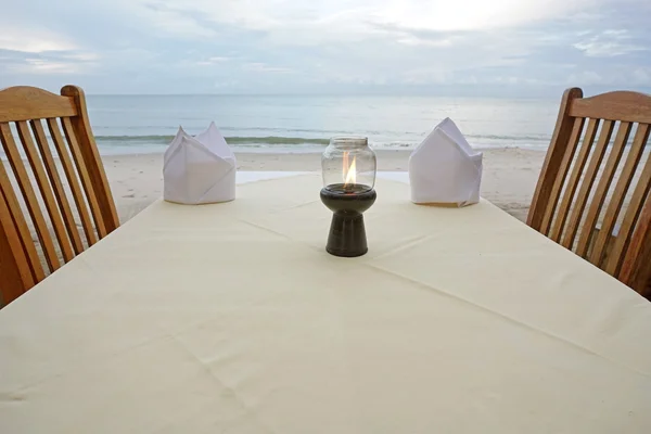 Table set up on the terrace of a restaurant by the sea