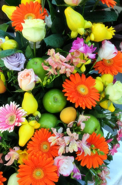 Colourful flower and fruit arrangement