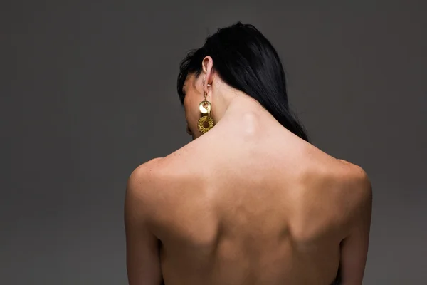 Naked back of a beautiful brunette woman