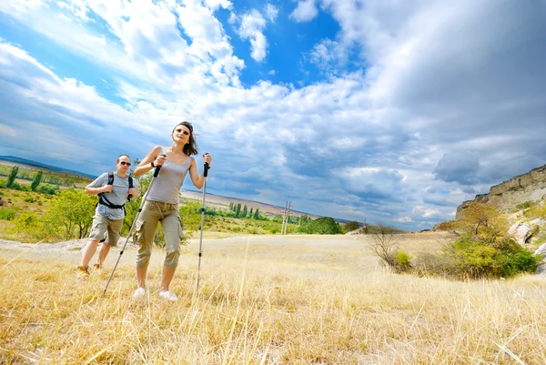 Adult man and woman are hiking