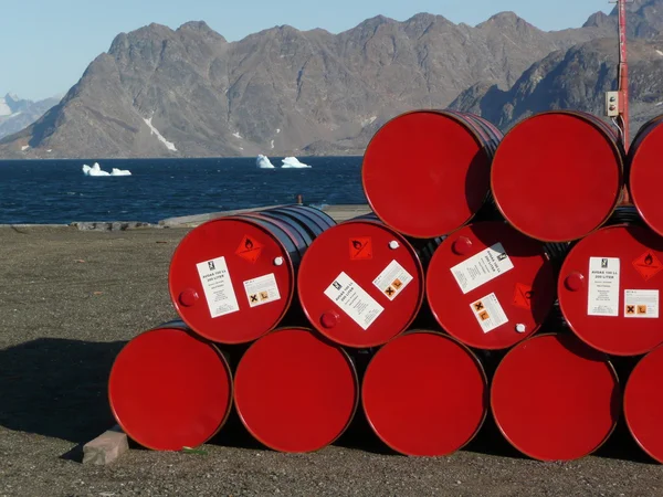 Red oil barrels stocked in kulusuk, east greenland