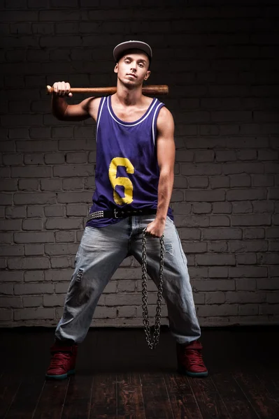 Hip-hop style man holding baseball bat and chain