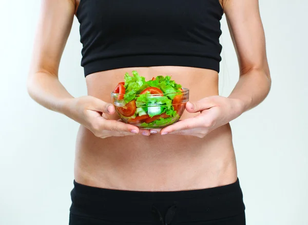 Slim sporty body. vegetables salad