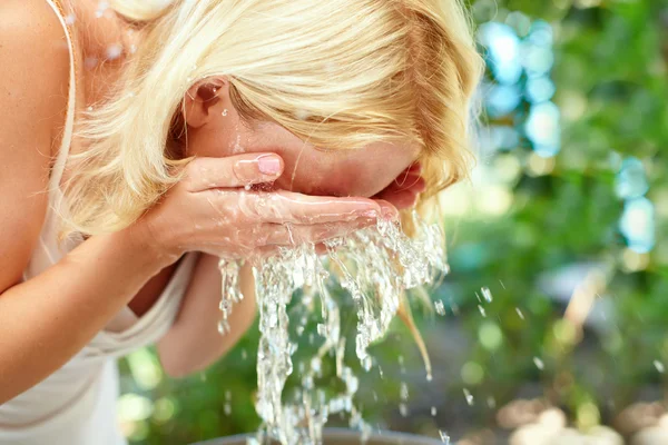 Young girl washing up in the morning outdoor