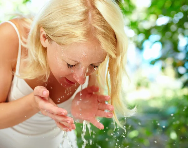 Pretty young girl washing up in the morning outdoor
