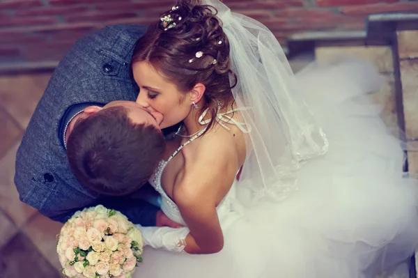 Beautiful bride and groom kissing. top view