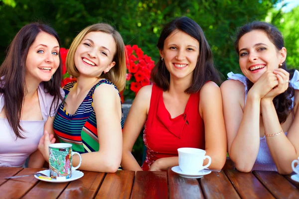 Beautiful female friends in summer cafe — Stock Photo #18186197