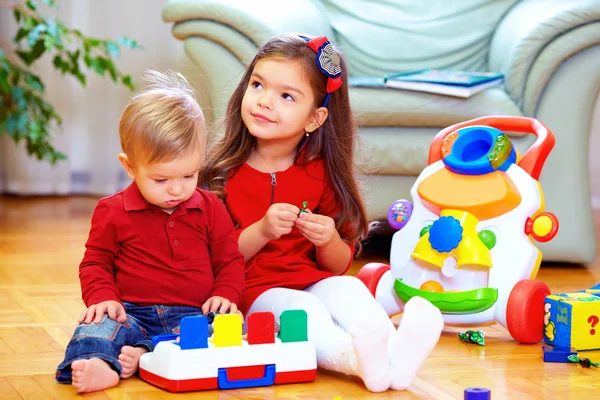 Cute babies playing toys at home