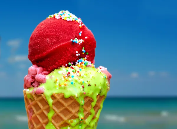 Tasty melting ice cream on summer background