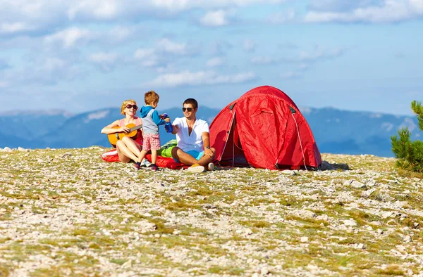 Happy family camping in mountains