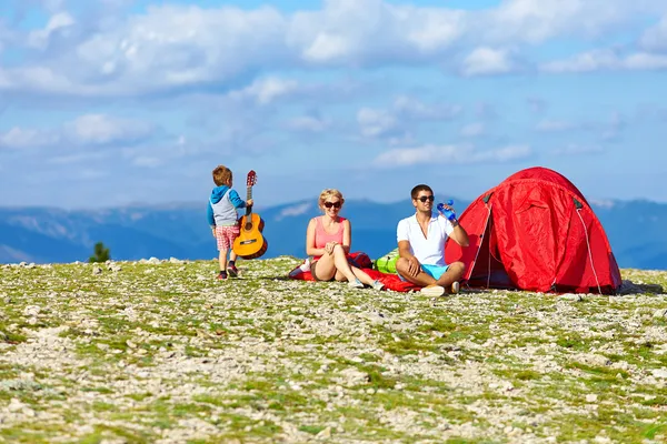 Happy family camping in mountains