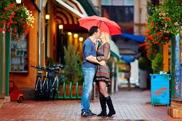 Couple in love kissing under the rain