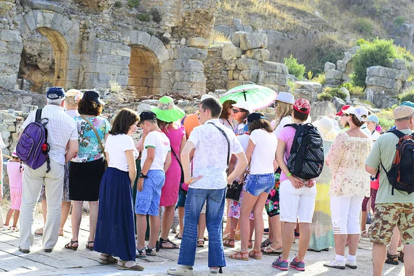 Tour Guide with Tourists on the Ruins