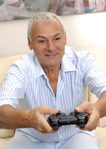 Senior man plays a computer game