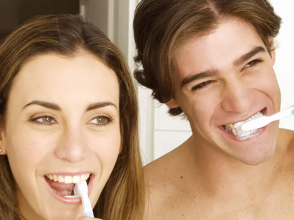 Couple washing their teeth