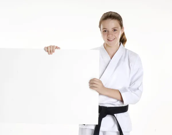 Martial arts girl holding a white panel.karate girl portrait holding a panel.Martial arts and karate kid portrait.