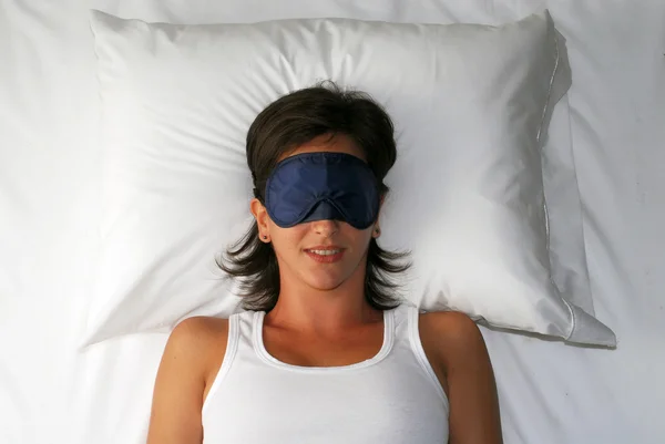 Beautiful sleeping young woman in sleep eye mask.