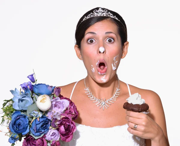 Funny bride eating cake