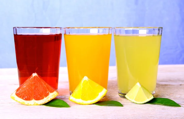 Citrus juices in glass from grapefruit, oranges, lime