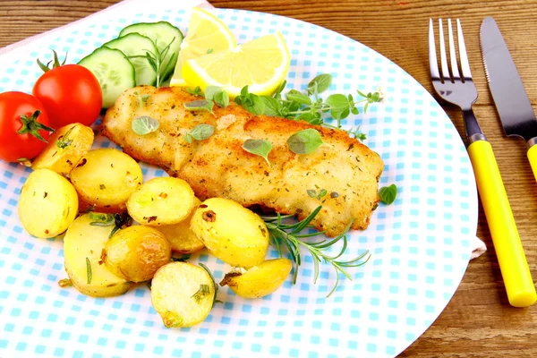 Rosemary potatoes with fried fish fillet and vegetables