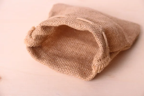 Empty jute sack on wood background