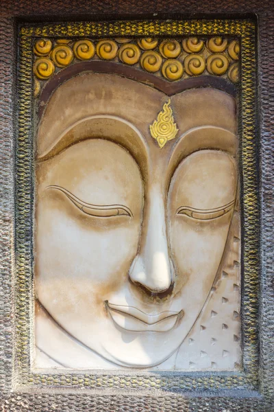 Buddha face sculpture