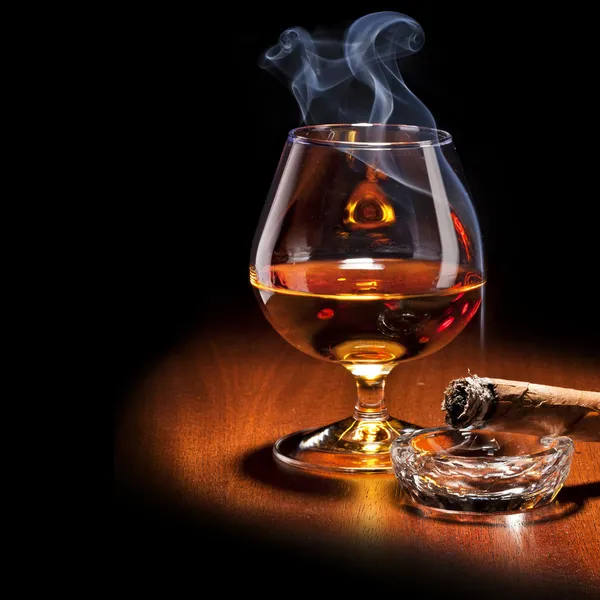 Cognac and Cigar with Smoke on dark background