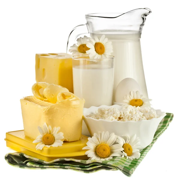 Dairy products on the wooden board table on white background