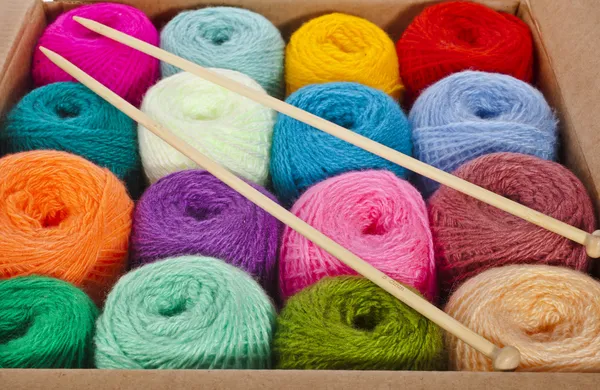 Cardboard box full colorful different thread balls of knitting yarn