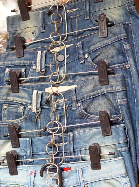 Shop vintage jeans hanging on a rack.