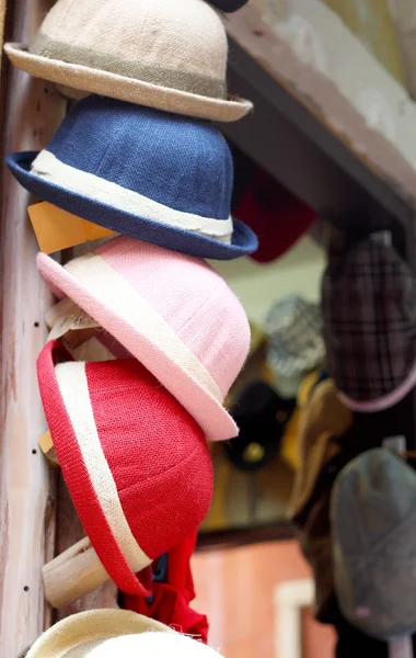 Hats are stacked for sale at the market