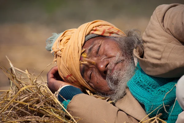 Very old poor taru man sleeping in Bardia, Nepal