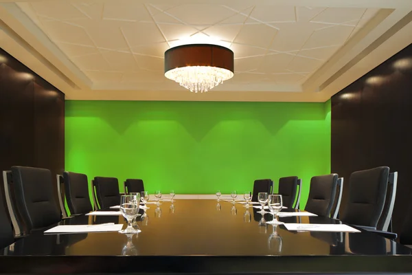 The boardroom table is set for a meeting