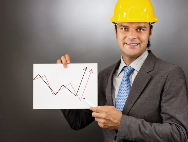 Young engineer drawing a rising graph, representing business gro