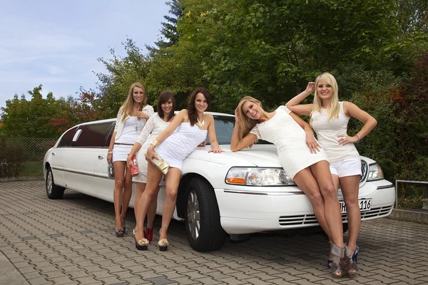 Five girls near the limousine