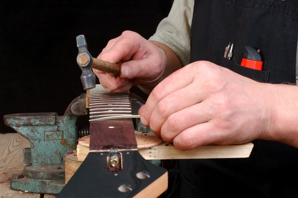 Luthier set in neck of the guitar frets