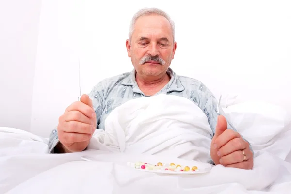 Elderly man eating meds