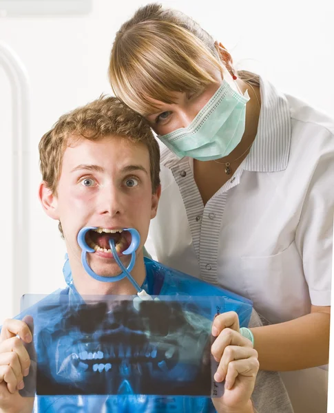 A dentist and her patient posing with funny facial expression.