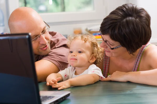 Happy family using laptop